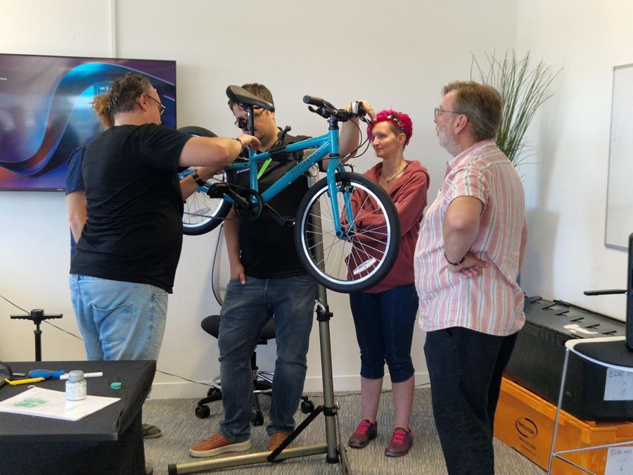 A team building bikes together at a charity build day