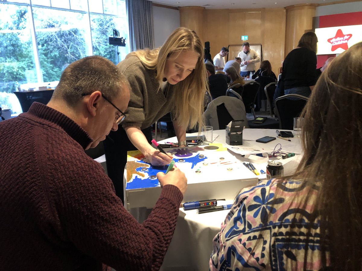 A team building at tables in an ordinary hotel function room