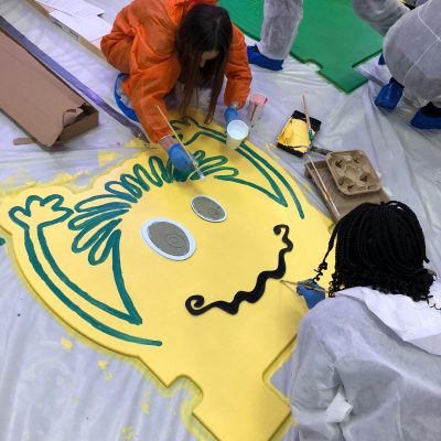 Team decorating a headboard at a live event