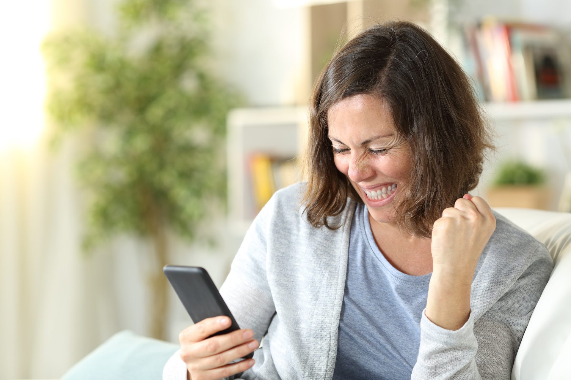 Woman on Phone - Business of Giving Virtual Team Building - The Business of Giving