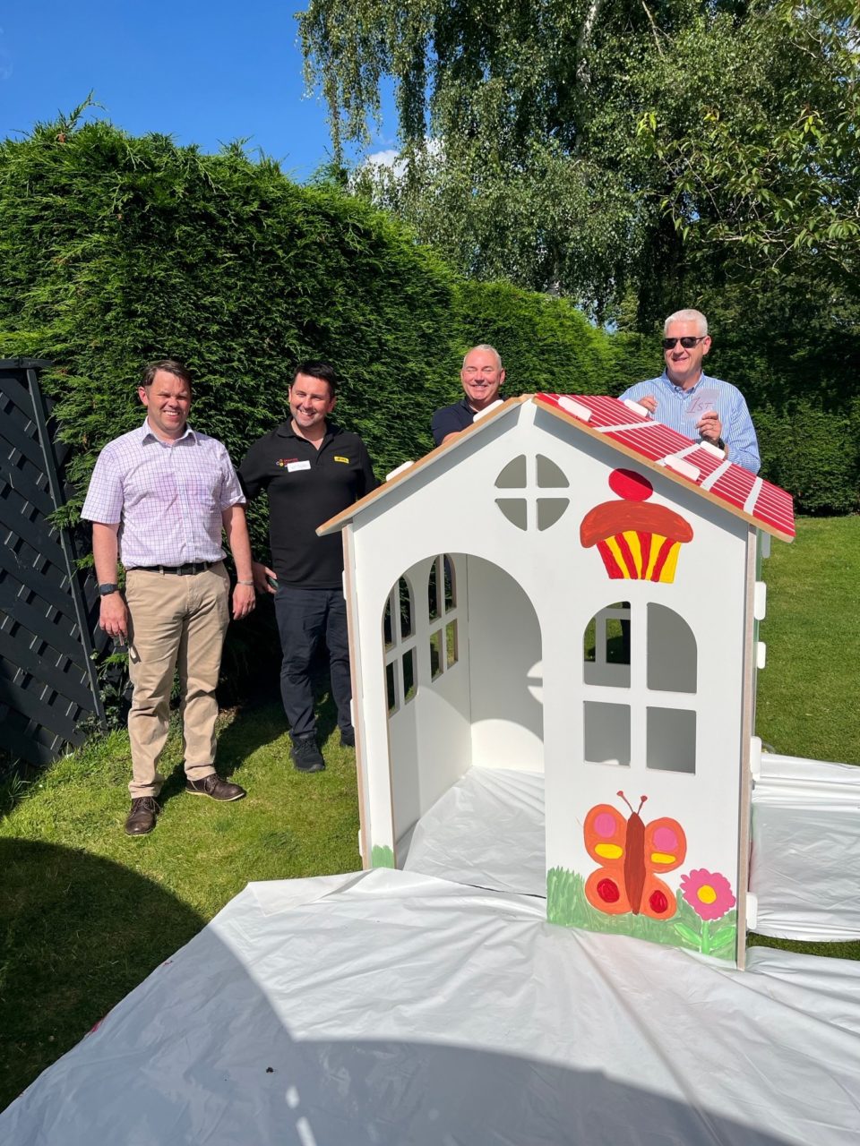 a fun house painted outside by a team
